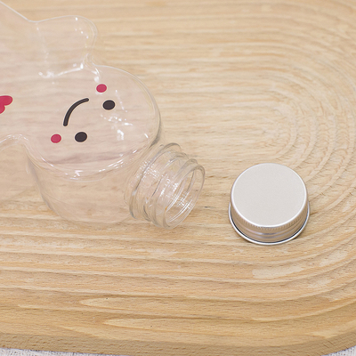 Bouteilles en plastique de jus de Noël avec le chapeau de preuve de fuite, bouteilles vides de thé de lait