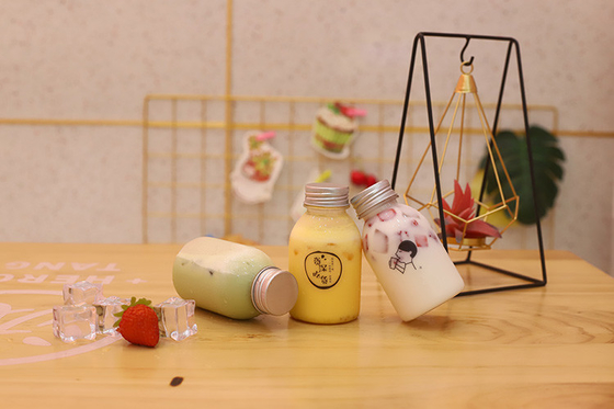 Bouteilles de thé au lait en plastique avec poignée pour une consommation efficace et efficace